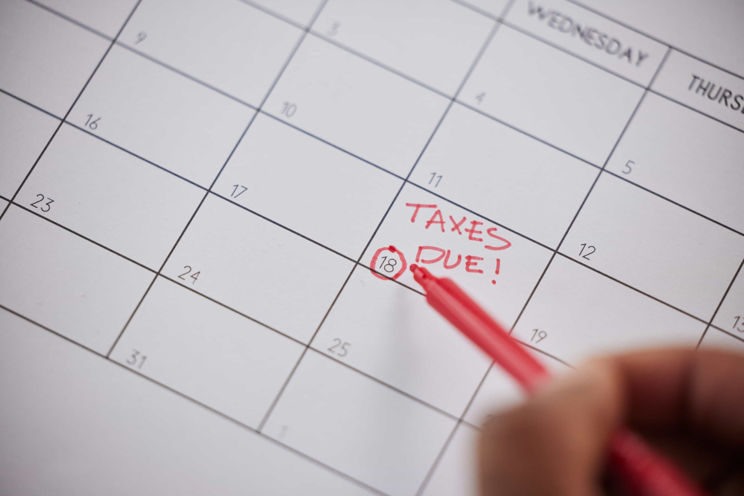 Calendar with important tax deadlines highlighted in red.