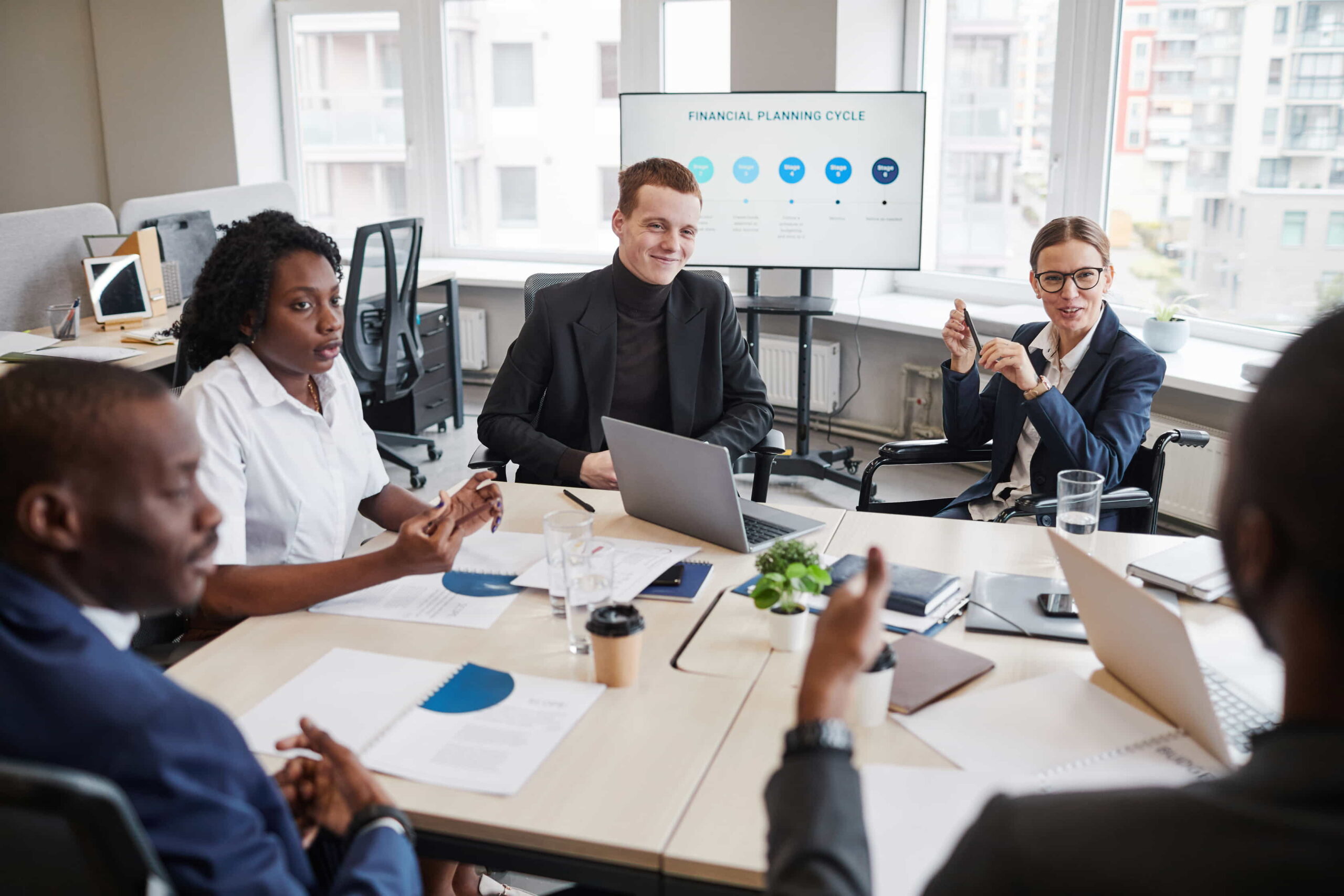 Busy office space with professionals engaged in financial planning.
